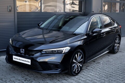 CIVIC 2.0 i-MMD Hybrid Elegance eCVT METÁLFÉNY AZ ÁRBAN. A KÉP ILLUSZTRÁCIÓ. AZ AUTÓ FEHÉR